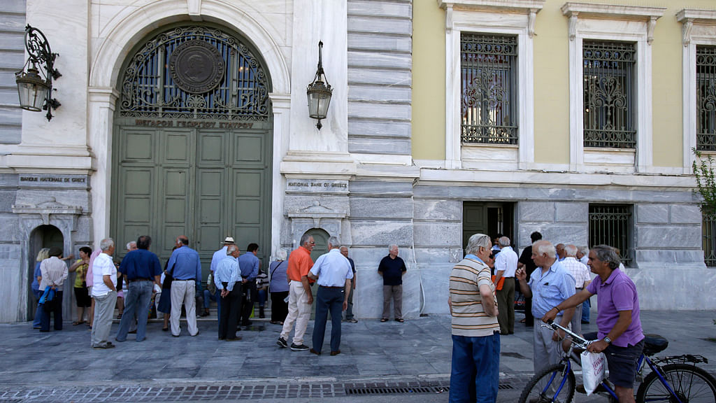 Elderly people, who usually get their pensions at the end of the month, wait outside a closed bank in Athens, Monday, June 29, 2015. (Photo: AP)&nbsp;