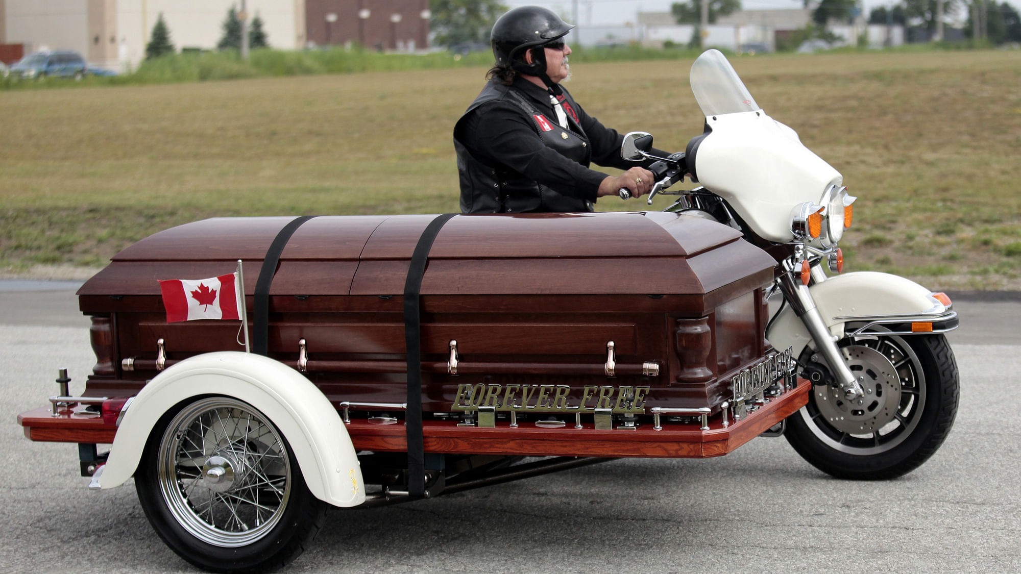 The casket with the remains of Bob Probert, former NHL hockey player for the Detroit Red Wings and Chicago Blackhawks, arrives on a motorcycle side car driven by George Winney for Proberts funeral service at the Christian Fellowship Church in Windsor. (Photo: Reuters)