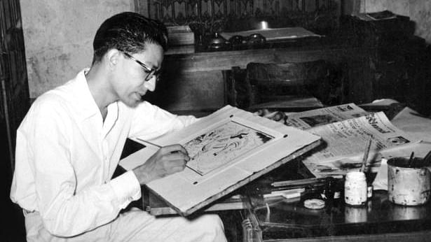 Archival photograph from Raj Thackeray’s book on Bal Thackeray showing him sketching a cartoon for the Free Press Journal. 