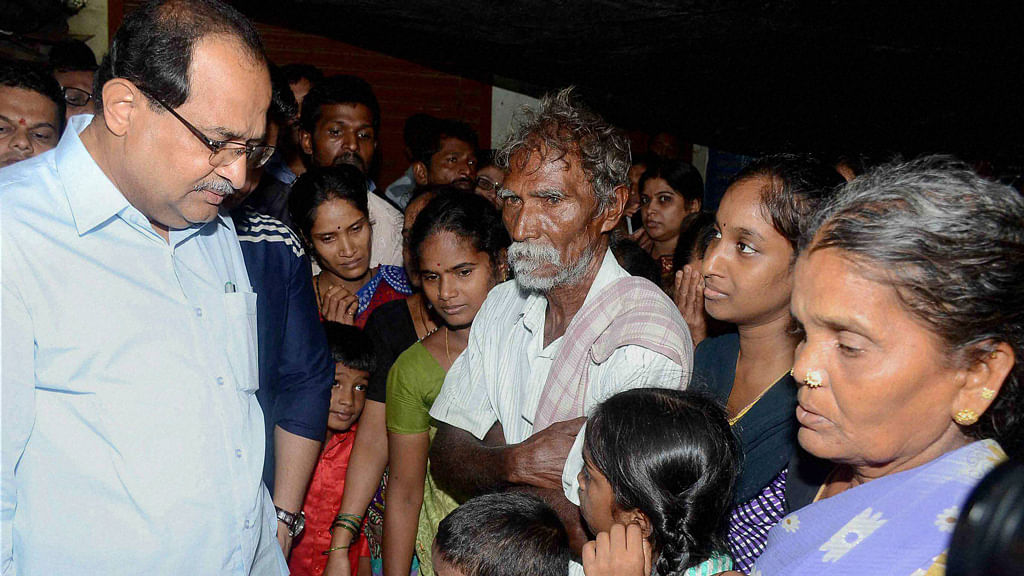 Mumbai: Opposition party leader Radhakrishna Vikhe Patil meets the family members of hooch tragedy victims at the slum area of Malvani in Mumbai. (Photo: PTI)