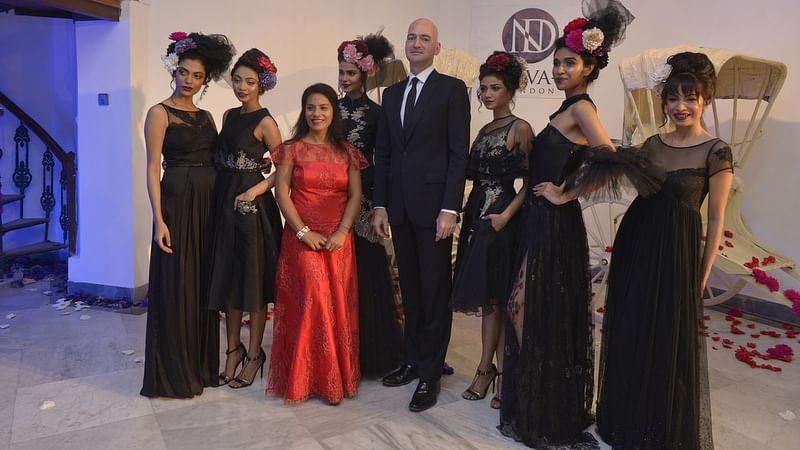 Fashion Designer Neeva Debnath (in red) along with models, and British Deputy High Commissioner Scott Furssedonn-Wood (fourth from R).