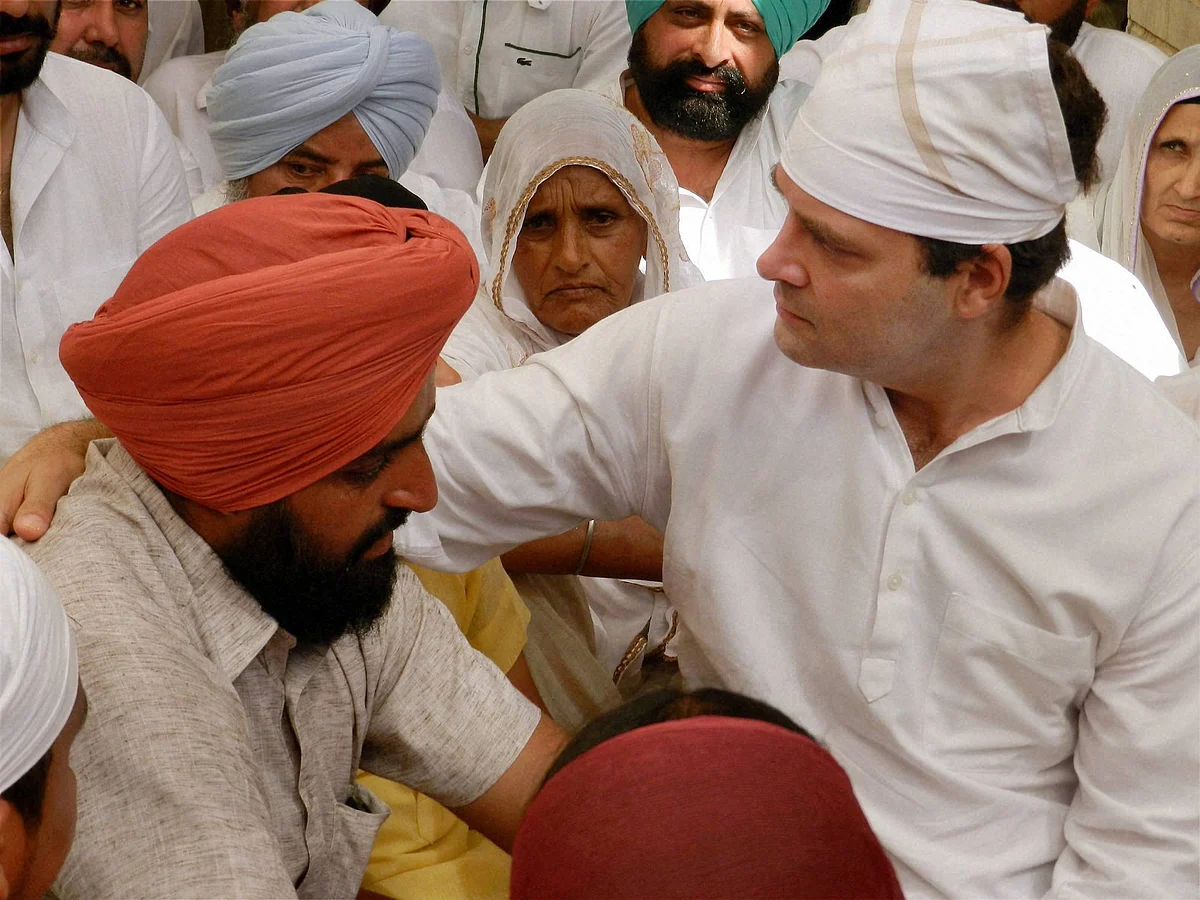 Congress Vice President Rahul Gandhi consoles the family of farmer Surjit Singh. (Photo: PTI) 