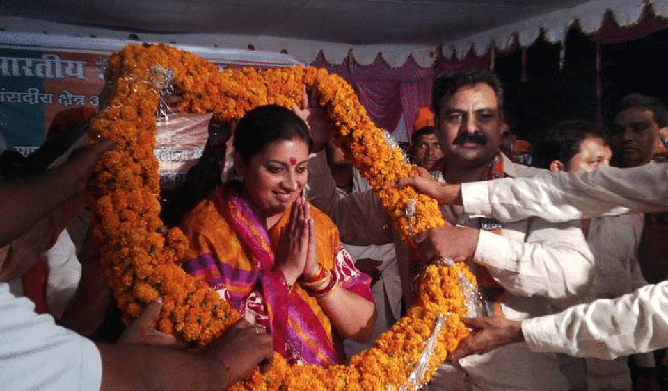 Union HRD Minister Smriti Irani, who’s in charge of education, being garlanded by party workers. (Courtesy:<a href="https://www.facebook.com/Smriti.Irani.Official?_rdr">Facebook.com/Smriti.Irani.Official</a>)