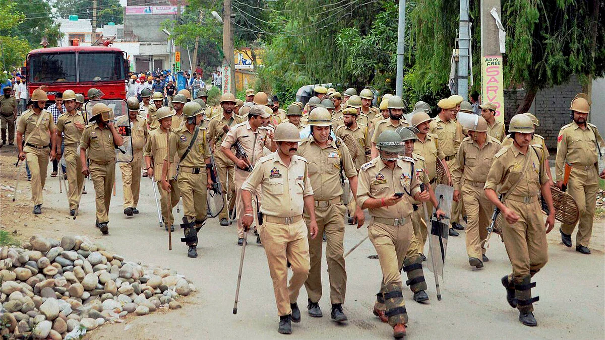 Security personnel carrying out a flag march in a street in Jammu on Friday. (Photo: PTI)