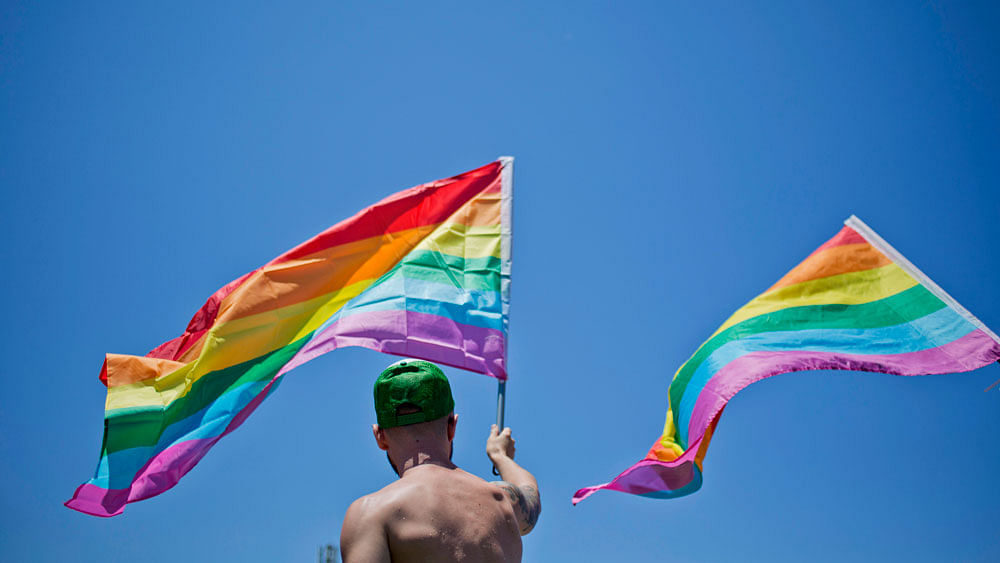 A man waves a rainbow flag during the annual Gay Pride Parade in Tel Aviv, Israel, Friday, June 12, 2015.  (Photo: AP)