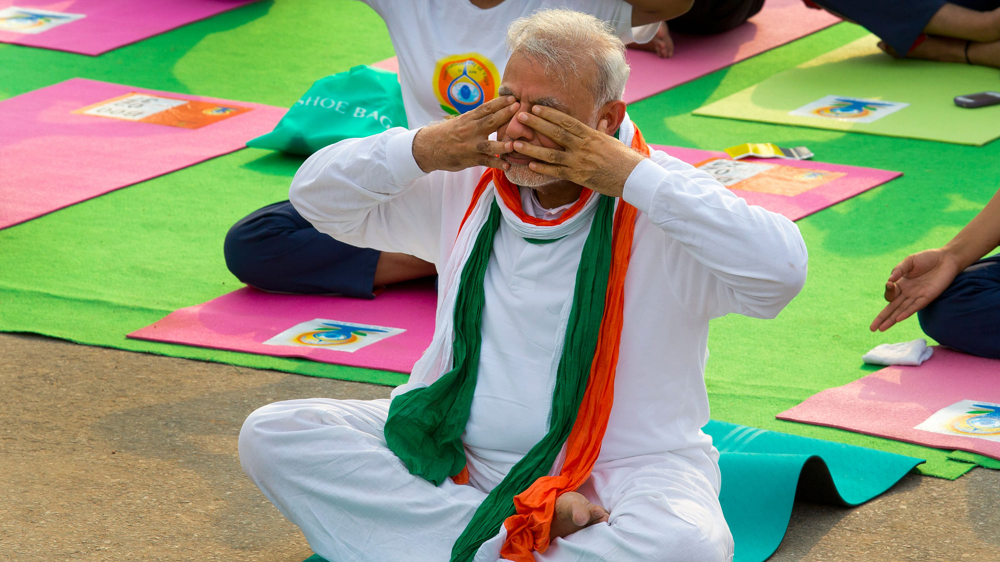 Prime Minister Narendra Modi, performs breathing exercise during yoga along with thousands of Indians on Rajpath, in New Delhi, India. (Photo: AP)