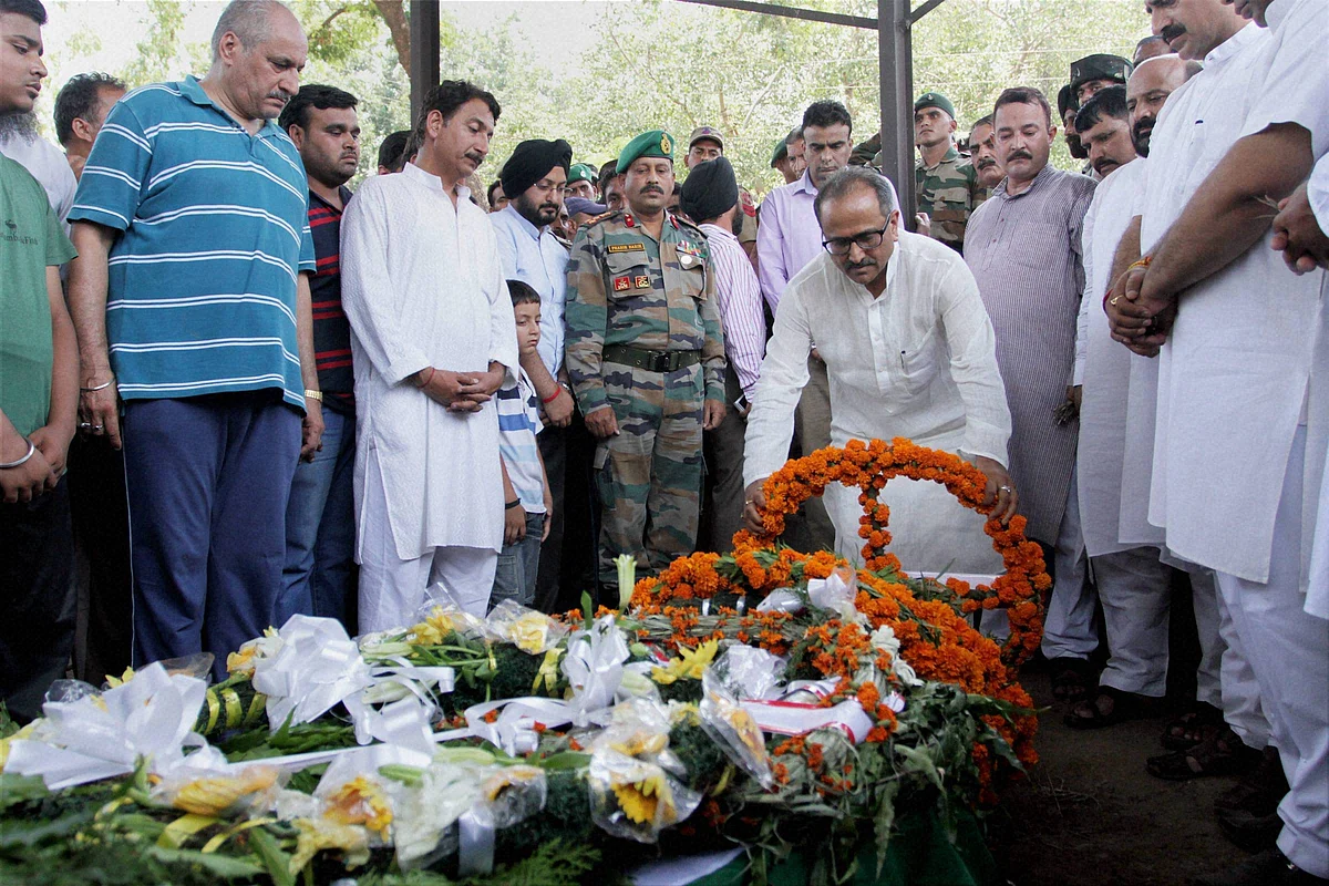 J & K Dy Chief Minister Nirmal Singh paying tribute, in Jammu on Sunday, to the soldier Sat Pal Bhasin, who was killed in an ambush in Manipur (Photo: PTI)