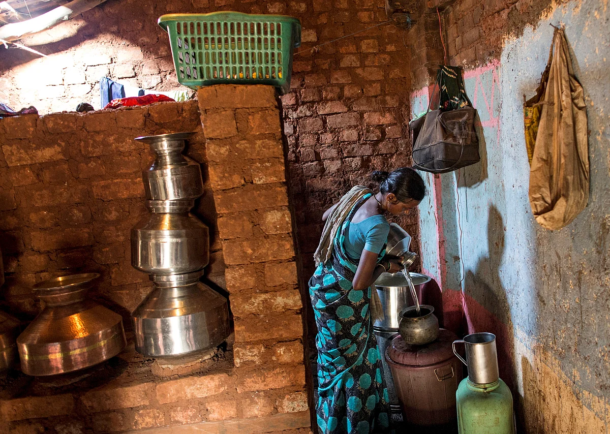 Shivarti, second wife of Namdeo, empties a water pitcher as she gets ready to fill water from a well outside Denganmal village, Maharashtra, India, April 21, 2015. (Photo: Reuters) 