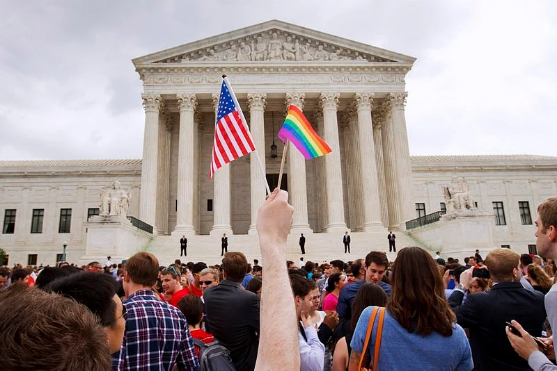 A man holds a U.S. and a rainbow flag outside the Supreme Court in Washington after the court legalised gay marriage nationwide in USA. (Photo: AP)