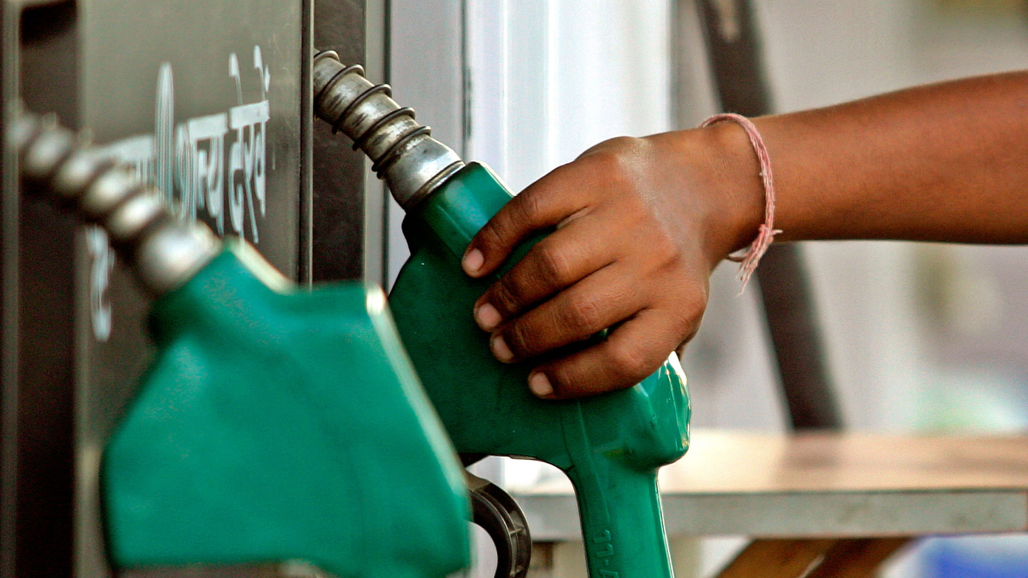 
















A worker lifts a petrol nozzle. (Photo Courtesy: Reuters)