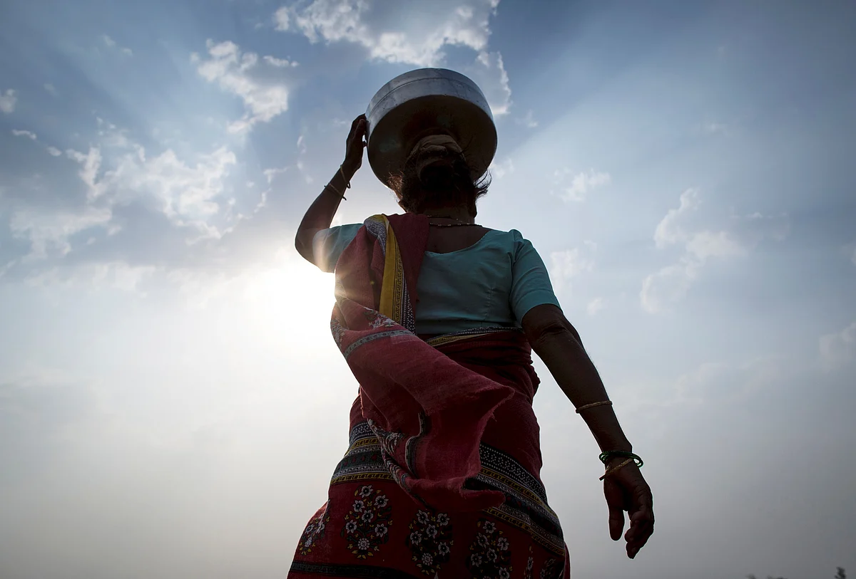 Bhaagi, third wife of Sakharam Bhagat, carries an empty metal pitcher as she walks to fetch water from outside her village in Denganmal, Maharashtra, India, April 20, 2015. (Photo: Reuters)