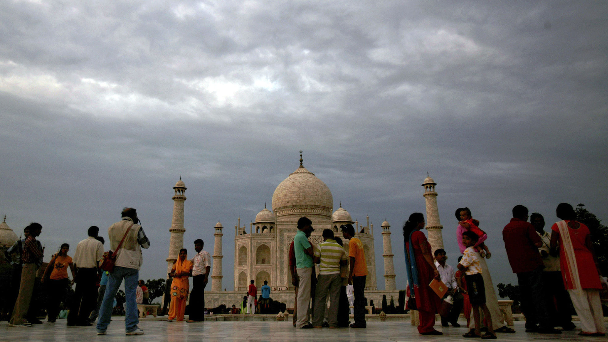 

Tourists stand in front of the historic Taj Mahal. (Photo: Reuters)