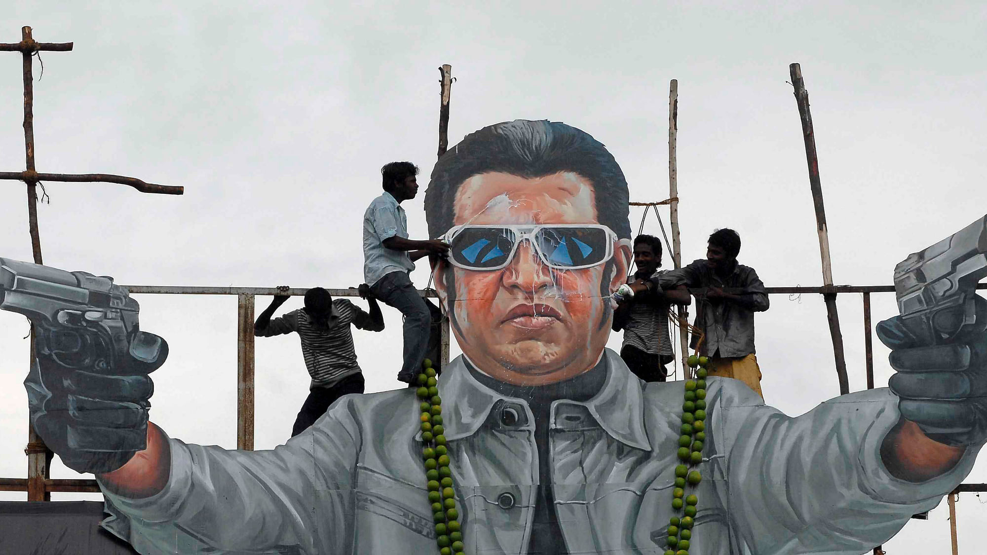 Fans pour milk over a cut out of Tamil superstar&nbsp;Rajinikanth from the film <i>Enthiran </i>(Photo: Reuters)