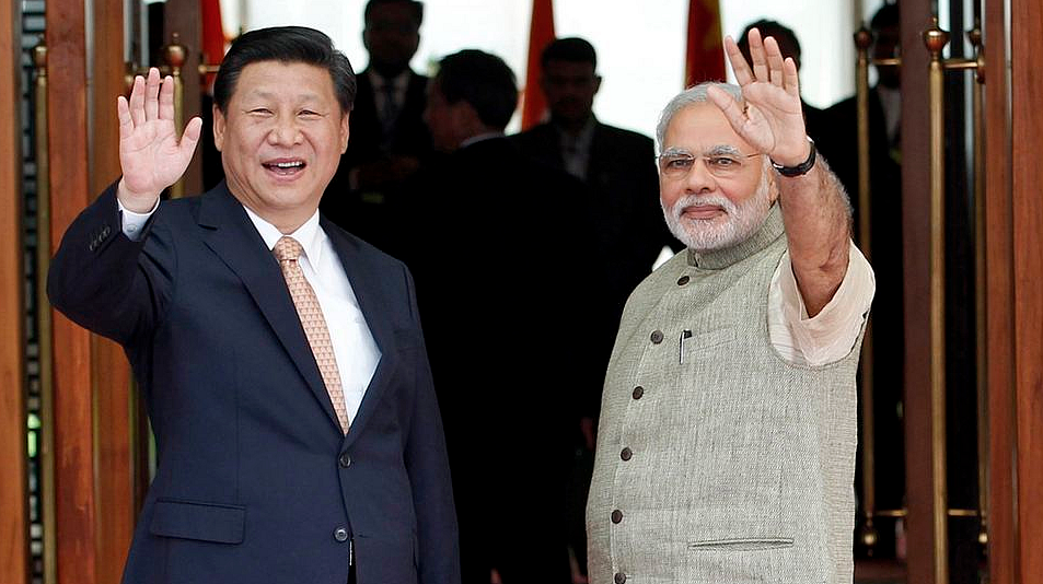 India’s Prime Minister Narendra Modi (R) and China’s President Xi Jinping wave to the media during a photo opportunity ahead of their meeting at Hyderabad House in New Delhi, September 18, 2014. (Photo: Reuters)