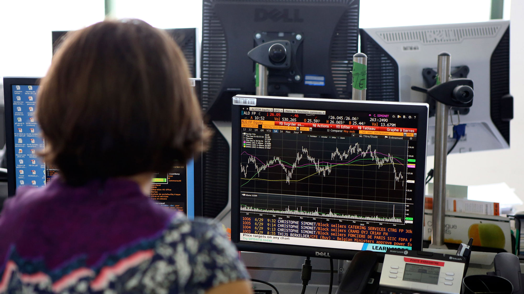 A trader checks financial data on a terminal in Paris on Monday. (Photo: AP)