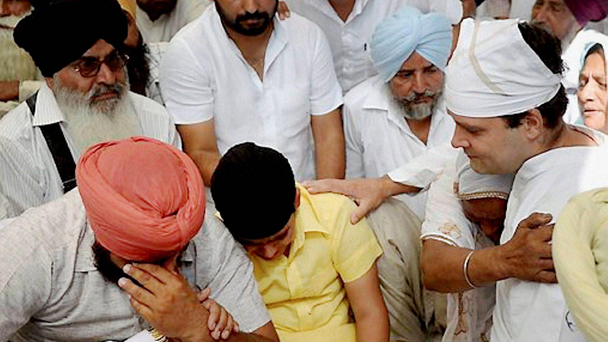 Congress Vice President Rahul Gandhi with the family of farmer Surjit Singh who committed suicide last week. (Photo: PTI)