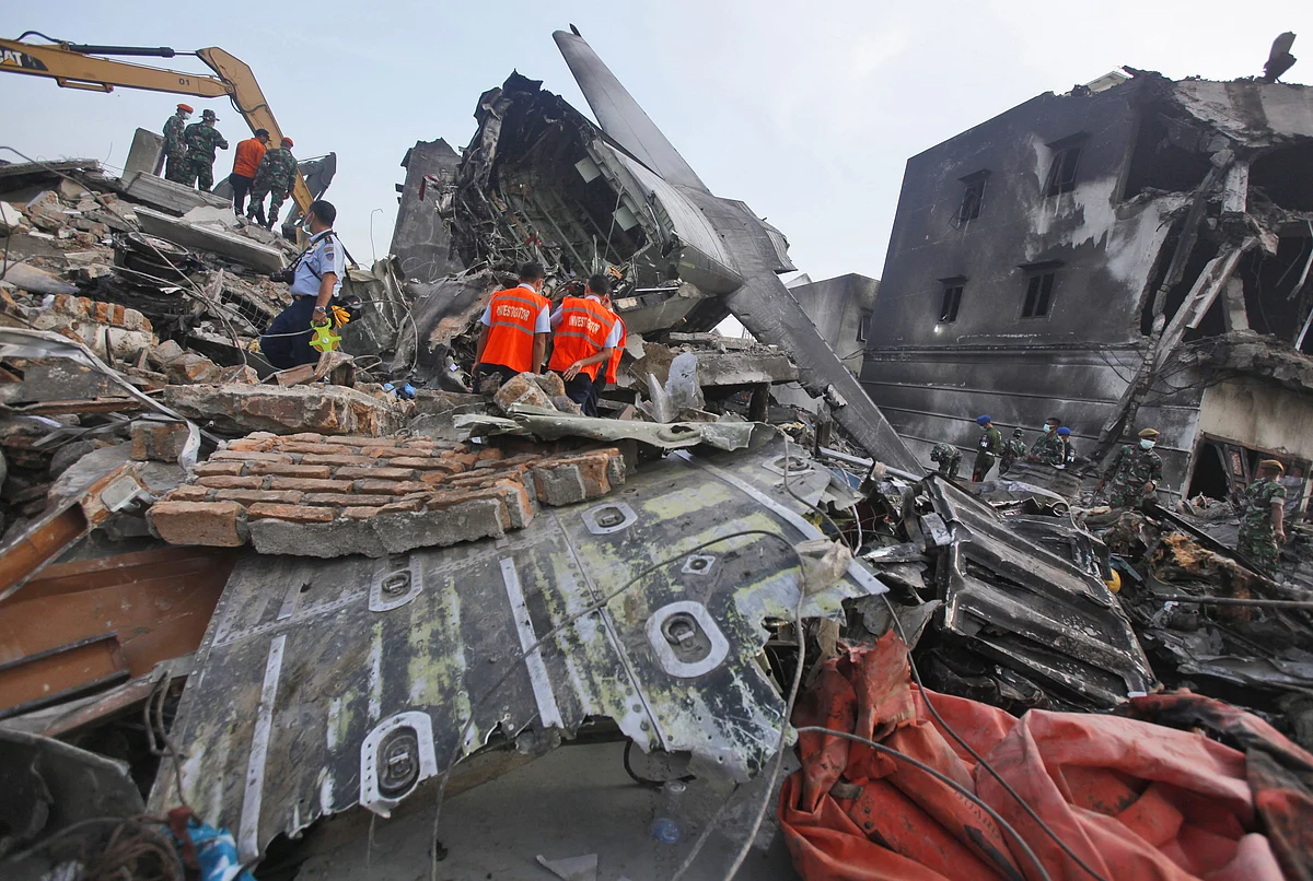 Investigators inspect the wreckage of the crashed air force transport plane in Medan in Indonesia. (Photo: AP)