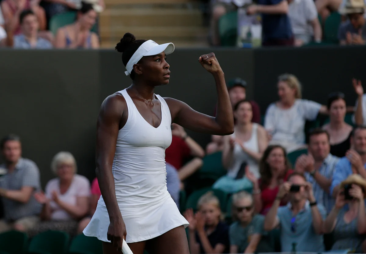 Venus Williams of the United States celebrates defeating Yulia Putintseva of Kazakhstan, during their singles match at the All England Lawn Tennis Championships in Wimbledon. (Photo: AP)