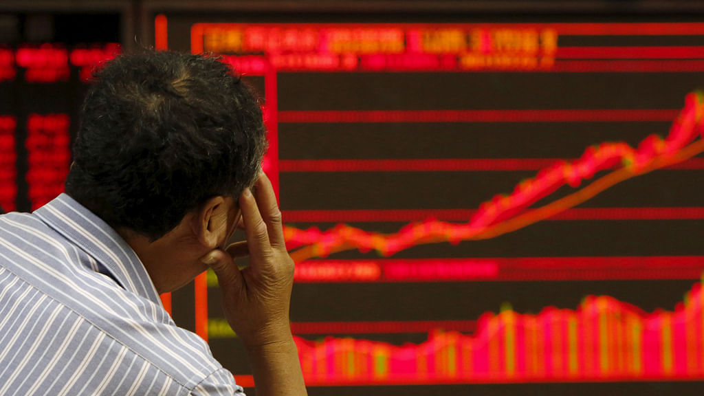 An investor watches an electronic board showing stock information at a brokerage office in Beijing, China, July 9, 2015. (Photo: Reuters)