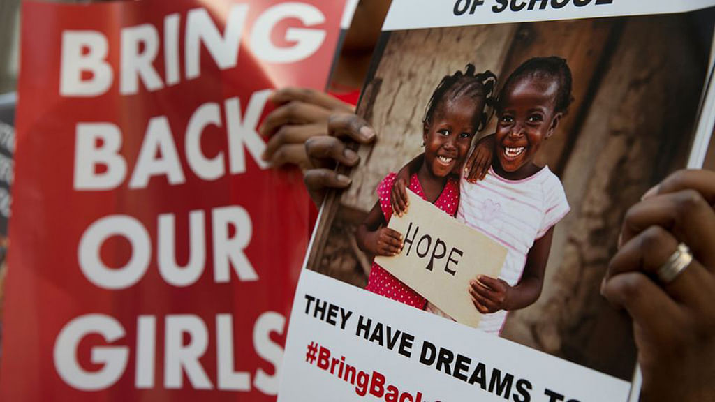 Protesters hold up “Bring Back Our Girls” placards on April 14, 2015, a year after the kidnapping. (Photo: AP)