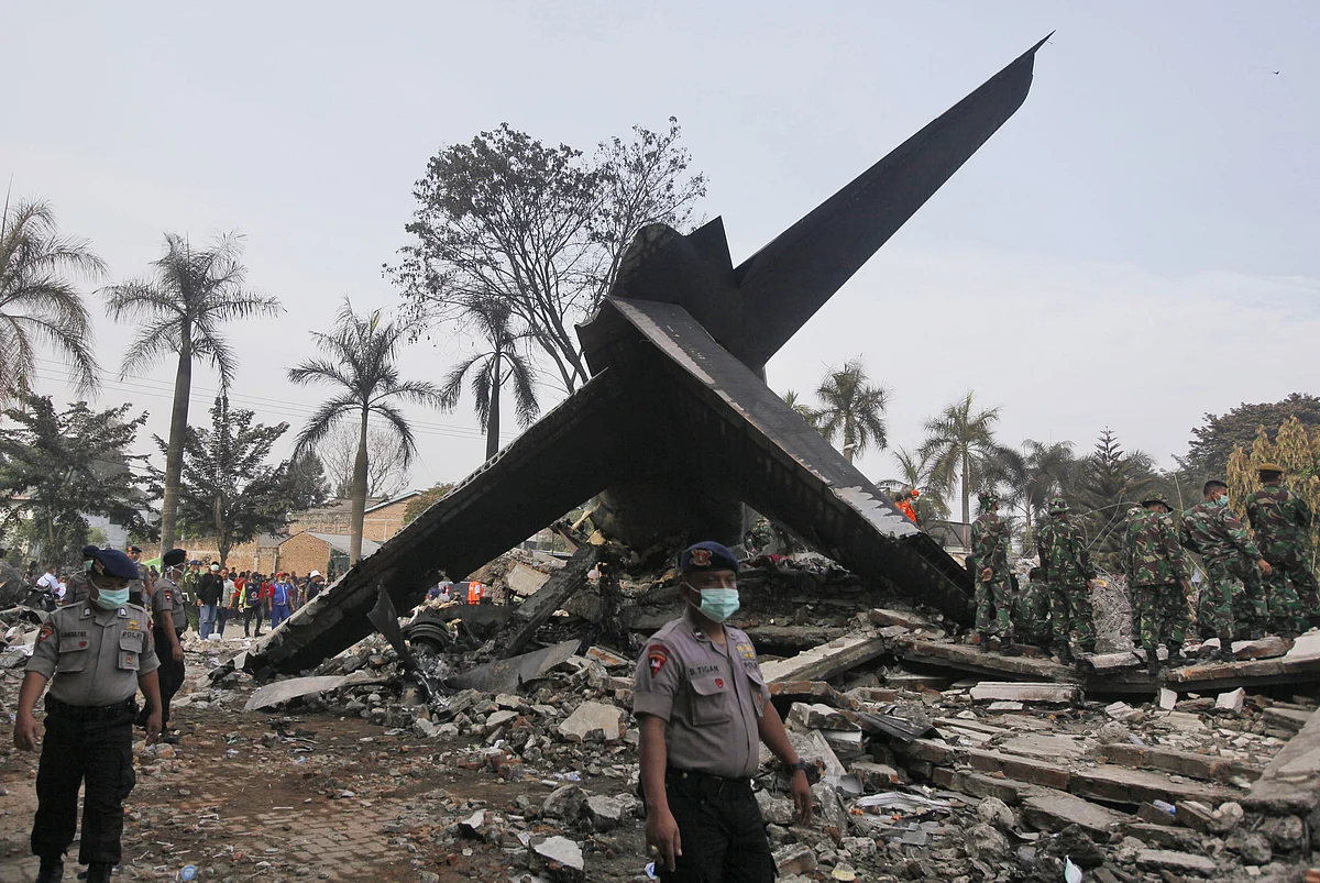 Rescuers search for victims at the crash site. (Photo: AP)