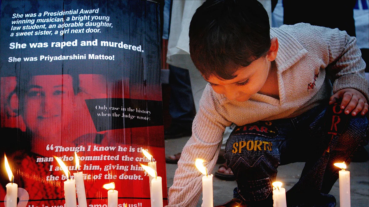 A child lights candles in memory of
Priyadarshini Mattoo in New Delhi, October 29, 2006. (Photo: Reuters)