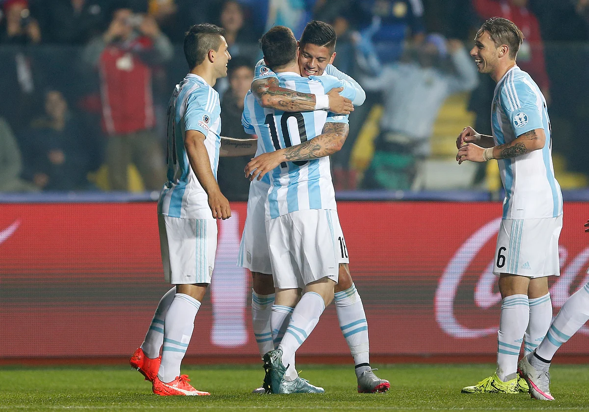 Argentina’s Marcos Rojo , center right, hugs teammate Lionel Messi after scoring the opening goal of the semi-final. (Photo: AP)<a></a>