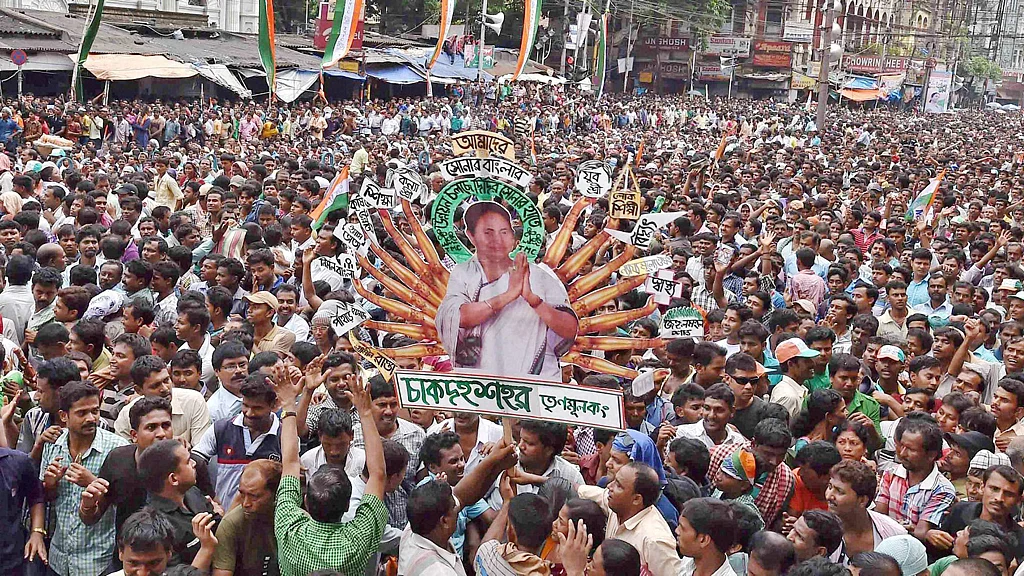 TMC activists hold up Mamata Banerjee’s cut-out during the rally. (Photo: PTI)