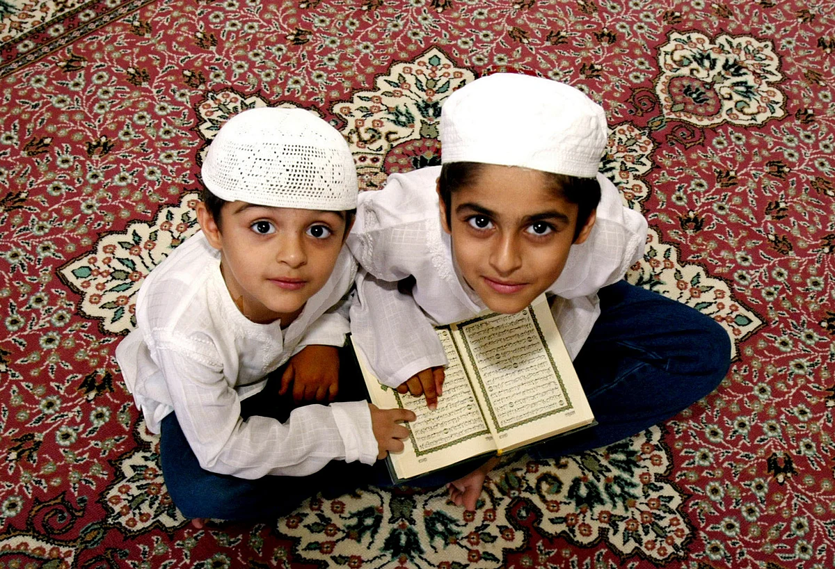 Muslim boys recite the holy Koran after a special prayer to mark the Eid-Milad festival in Dubai April 20, 2005. Muslims around the world today celebrate Eid-Milad, the anniversary of the birth of Prophet Mohammed, by offering special prayer. (Photo: Reuters)