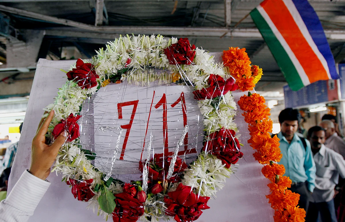A man lays a wreath on a memorial. Seven bombs went off in Mumbai killing at least 183 people. (Photo: Reuters)