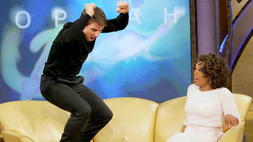 Tom Cruise jumps on Oprah’s couch.