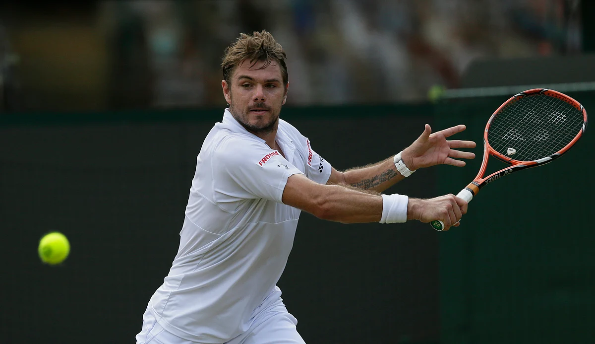 Stan Wawrinka of Switzerland makes a return to Victor Estrella Burgos of the Dominican Republic during their singles match in Wimbledon. (Photo: AP)