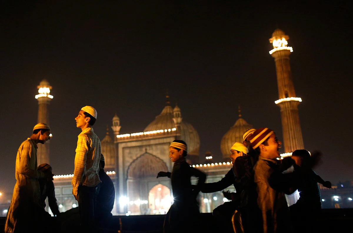 Muslim children celebrate after Eid ul-Fitr was announced at the illuminated Jama Masjid (Grand Mosque) in the old quarters of Delhi August 8, 2013. The Eid ul-Fitr festival marks the end of the holy month of Ramadan. (Photo: Reuters)