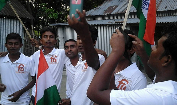 A section of Indians living in enclaves in Bangladesh walk through their village, making clear which side of the border their loyalties lie. (Photo: BBEECC, Bharat Bangladesh Enclaves Exchange Coordination Committee)