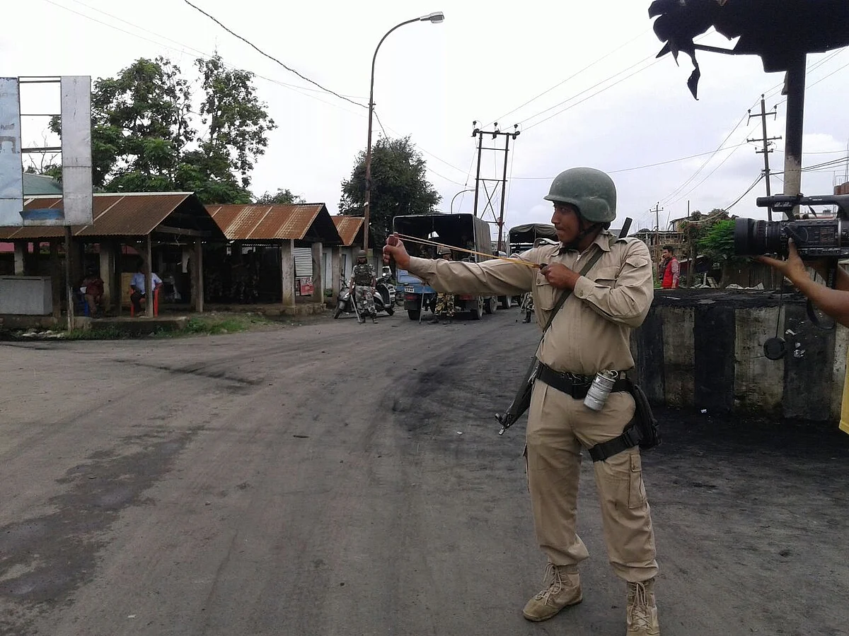 A policeman uses a catapult in Imphal. (Photo: Sunzu Bachaspatimayum)
