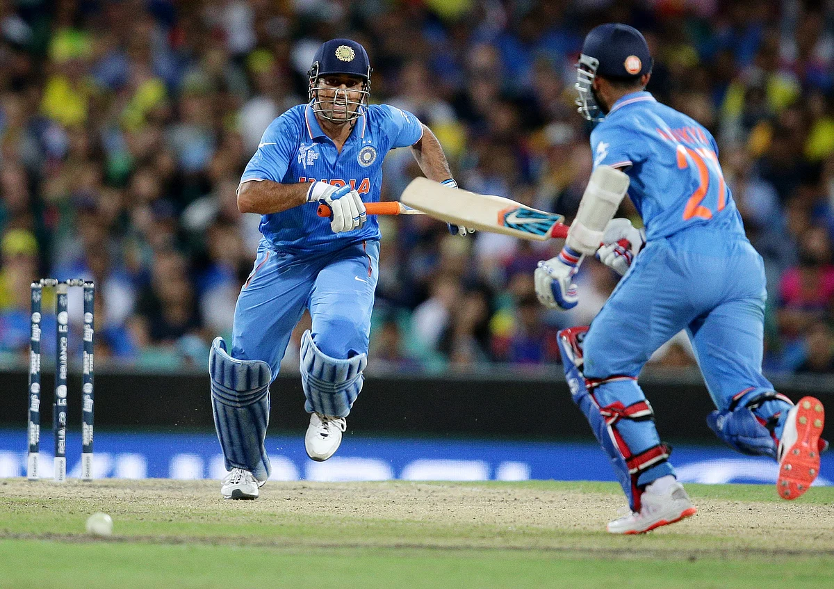 India’s MS Dhoni, left, runs down the wicket with teammate India’s Ajinkya Rahane while batting against Australia during the World Cup semifinal. (Photo: AP)