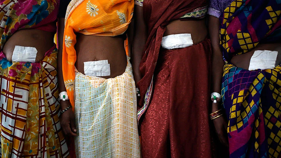 Women, who underwent sterilization surgery at a government mass sterilisation camp, pose for pictures inside a hospital at Bilaspur district in the eastern Indian state of Chhattisgarh. (Photo: Reuters)
