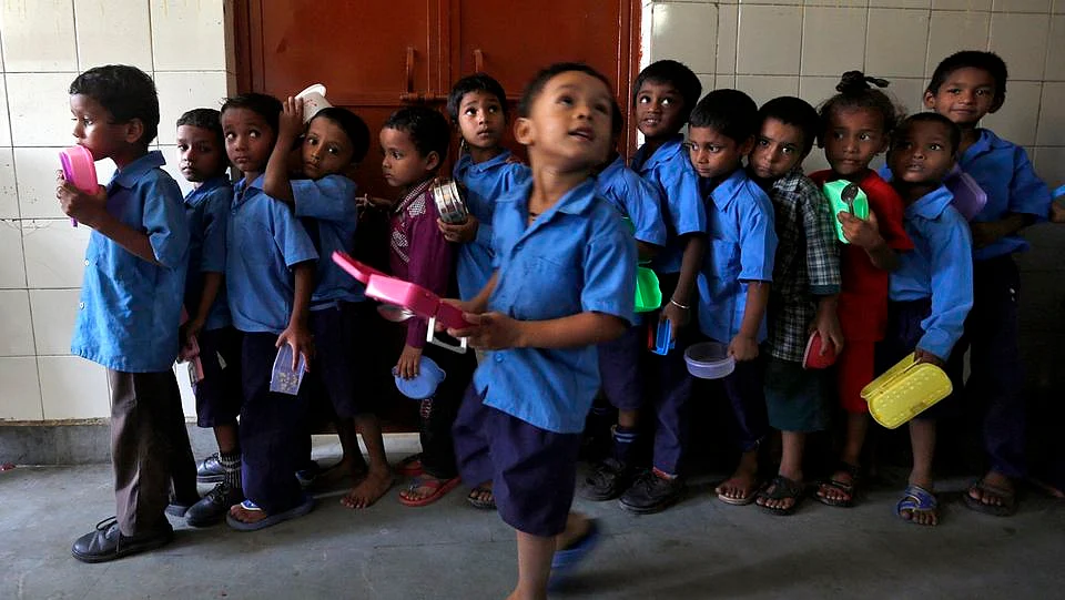 Children line up in a school to receive their mid-day meal. (Photo: Reuters)