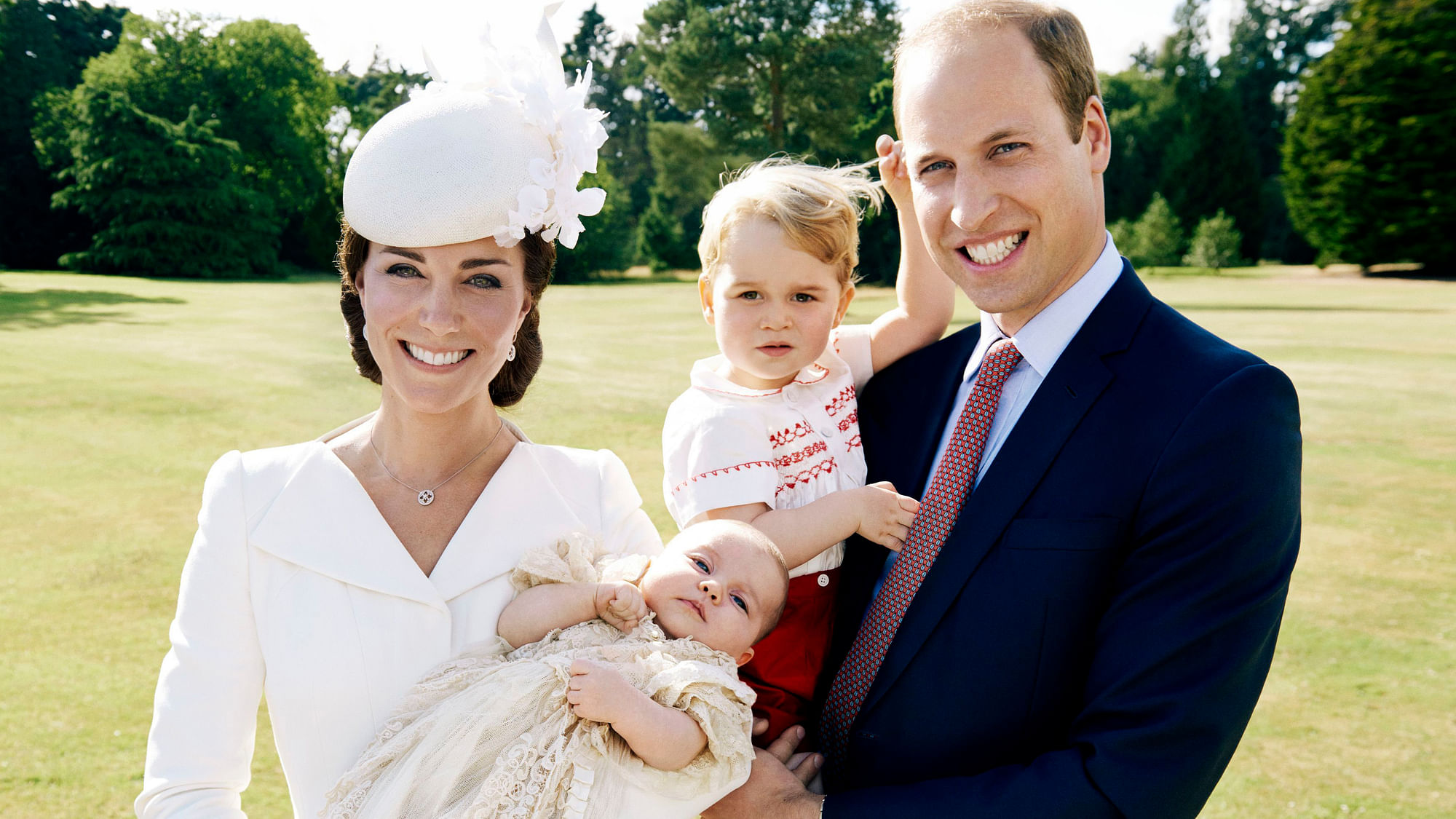 Britain’s Prince William, and Kate Duchess of Cambridge as they hold their children, Prince George, 2nd right, and Princess Charlotte in the grounds of Sandingham House in England after the christening of the princess on Sunday July 5, 2015. (Photo: AP)
