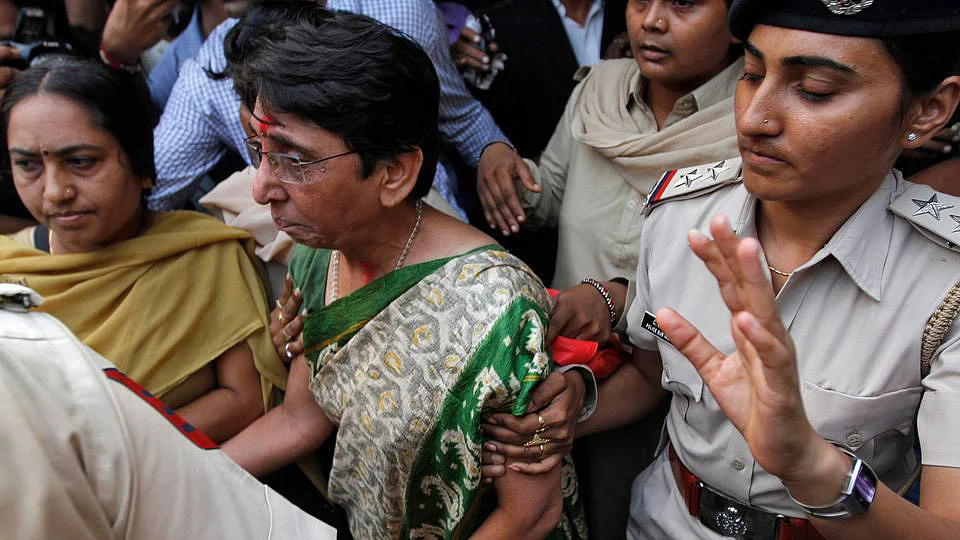 Maya Kodnani, former Gujarat minister, being escorted to prison by police after a court hearing in Ahmedabad in 2014 after conviction in the Naroda Patiya case. 