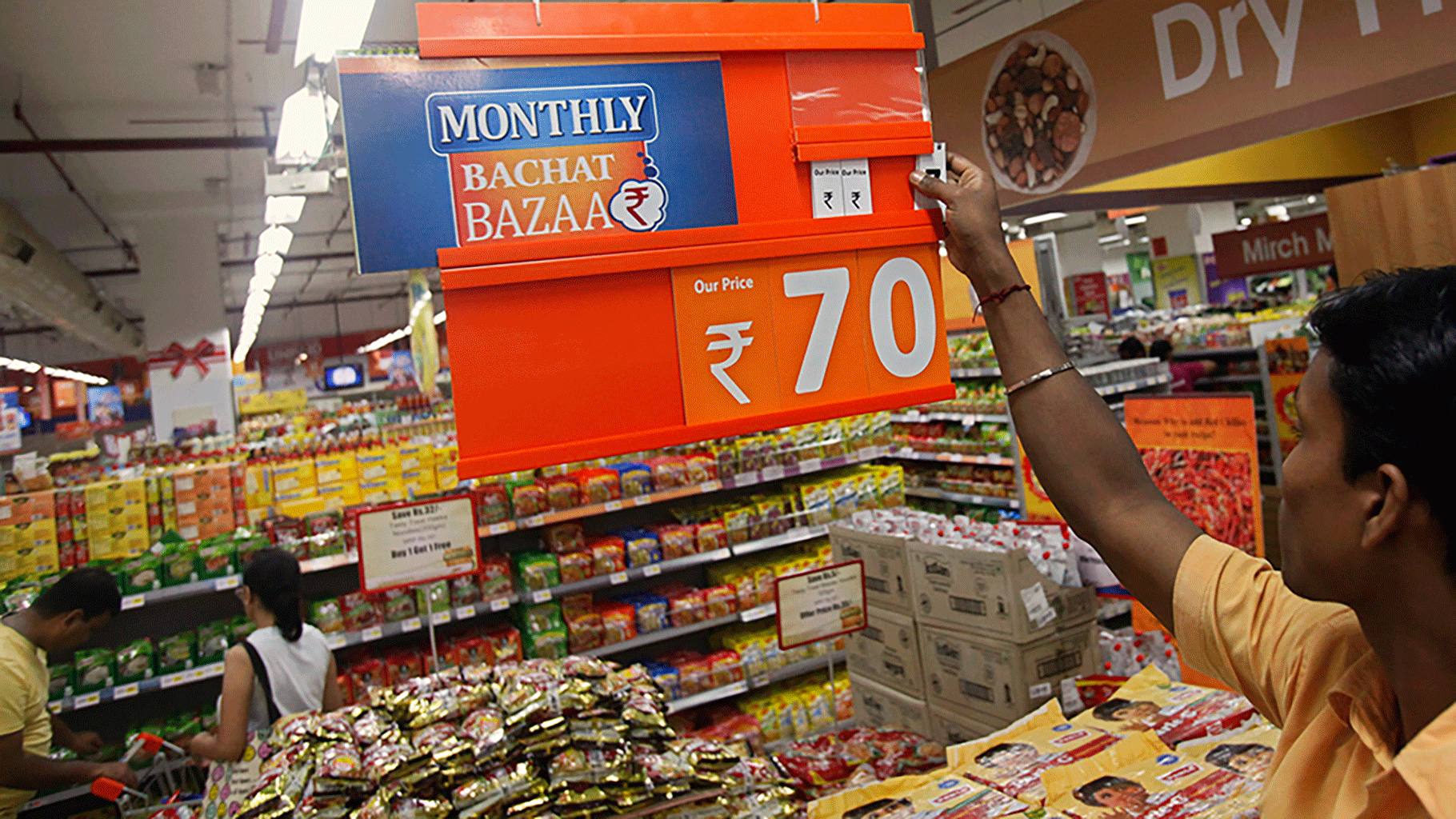 An employee changes the price tag of a product at the Big Bazaar retail store.