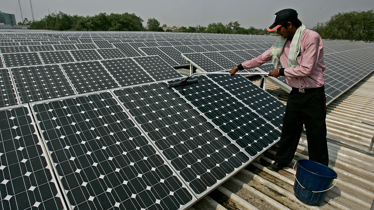 A solar panel is cleaned using a wet sponge. (Photo: iStockphoto)