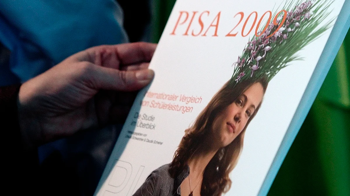 A person holds the 2009 OECD education report, the PISA (Programme for International Student Assessment) study, during a news conference in Vienna, December, 2010. (Photo: Reuters)