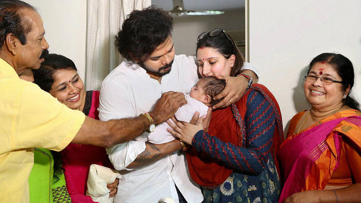 S Sreesanth celebrates with his family,
after discharged by a Delhi court in IPL scam, at his residence in Kochi on Sunday. (Photo:&nbsp;PTI)