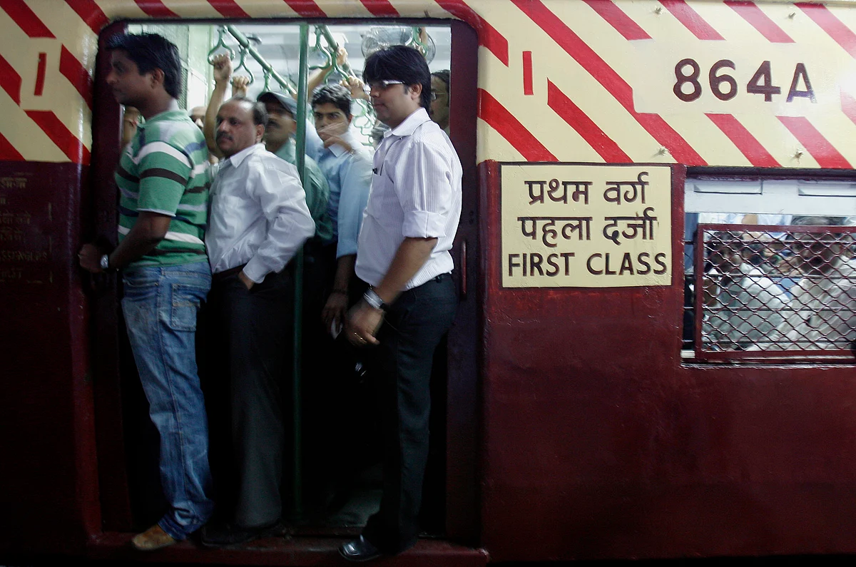 Train commuters travel in the refurbished coach that was damaged in one of the bomb blasts at Mahim station in Mumbai. (Photo: Reuters)