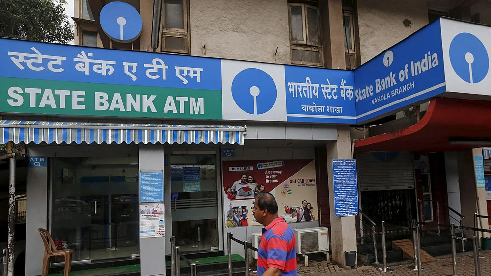 A man walks past a State Bank of India ATM in Mumbai. 