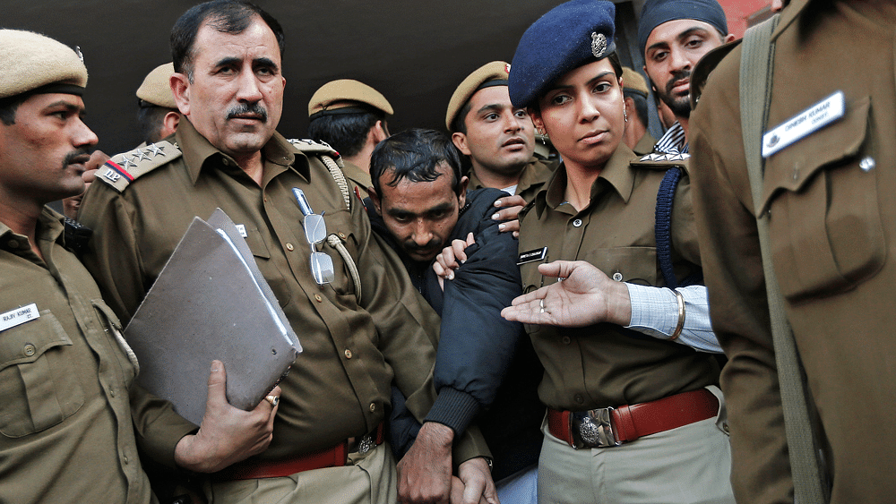Policemen escort Uber taxi&nbsp;driver Shiv Kumar Yadav (Centre in black jacket) who is accused of a rape outside a court in New Delhi December 8, 2014.&nbsp;(Photo: Reuters)