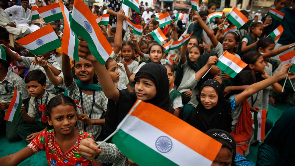 People wave flags to mark Independence Day. (Photo: AP)