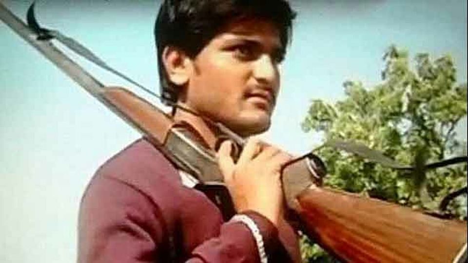 22-year old Hardik Patel is the “face” of the Patel agitation for reservation. He says images of him with guns in propaganda videos is only for dramatic effect and not to advocate violence. (Photo Courtesy: Screen grab from <a href="https://www.youtube.com/watch?v=3i0chqnO7QA">YouTube Video</a>)