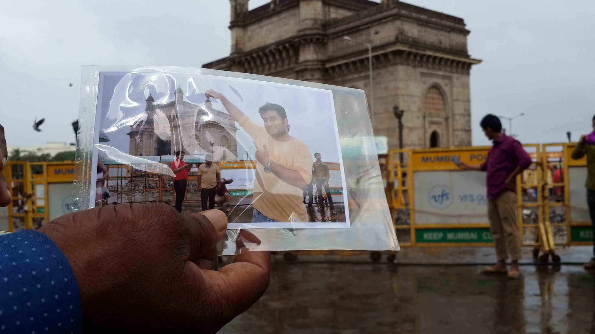 Photographer Jitendra Singh hands out a print out of a customer’s photograph (Photo: Twish Mukherjee)